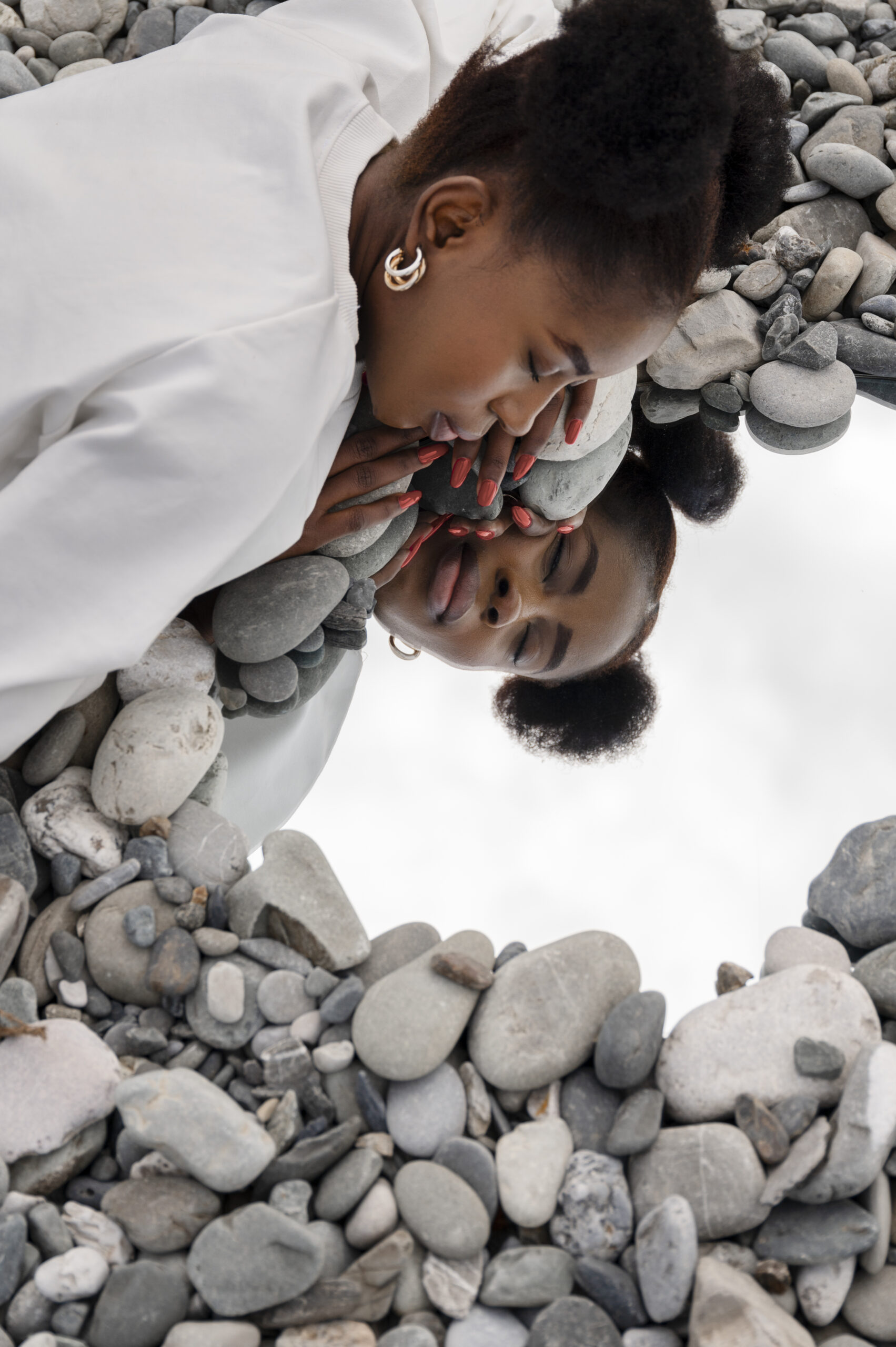 young-woman-dressed-white-posing-with-mirror-rocks